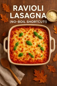 A golden, bubbling baked ravioli lasagna in a white casserole dish topped with melted mozzarella and sprinkled with fresh basil, served with garlic bread and salad on the side.